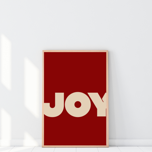 Plakat z napisem Joy do salonu to nowoczesna dekoracja, która dodaje wnętrzu energii i stylu